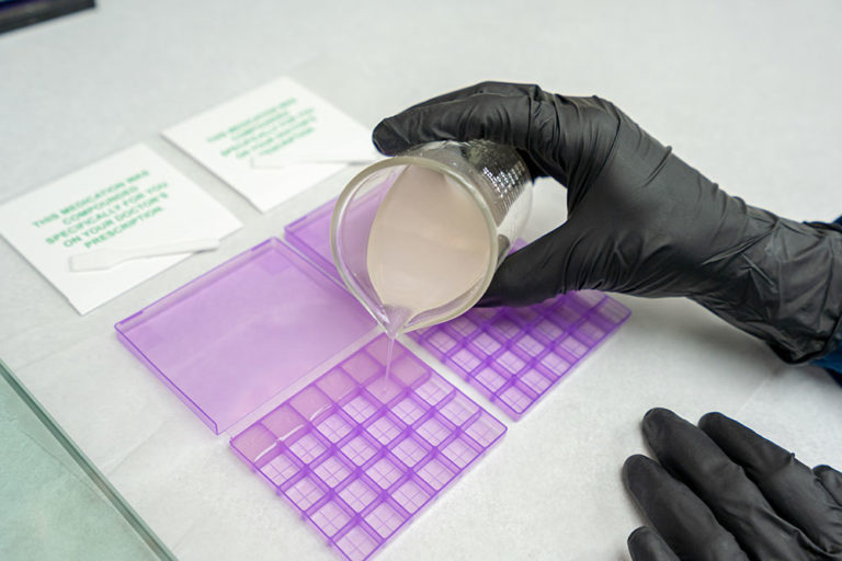 Compound Medication for Pain, Image of one of our pharmacists pouring a drug compound order with a beaker.