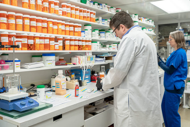 Compounding Services, Image of one of our staff working on a customers drug compound prescription.