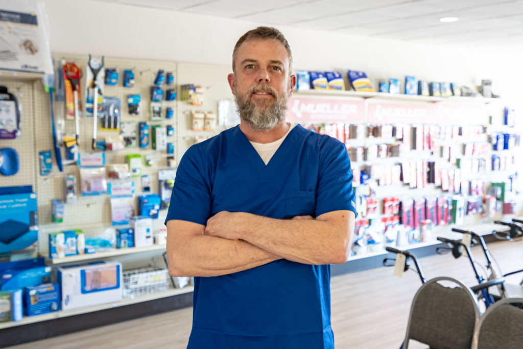 Medical Supplies and Equipment, image of one of our pharmacist standing next to our medical supplies.