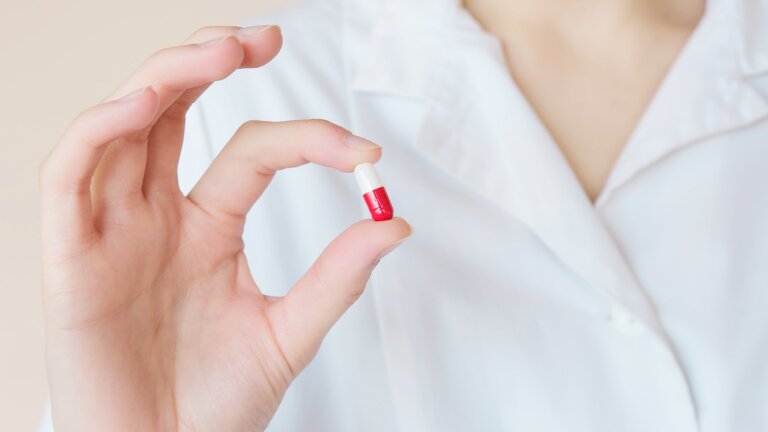 Pharmacy Compounding Formulations. image of a woman holding a Compounding Formulation pill